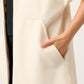 ABRIGO SEMI LARGO MINIMALISTA DE PAÑO COLOR IVORY CON BOLSILLOS TIPO CANGURO RIVOLI